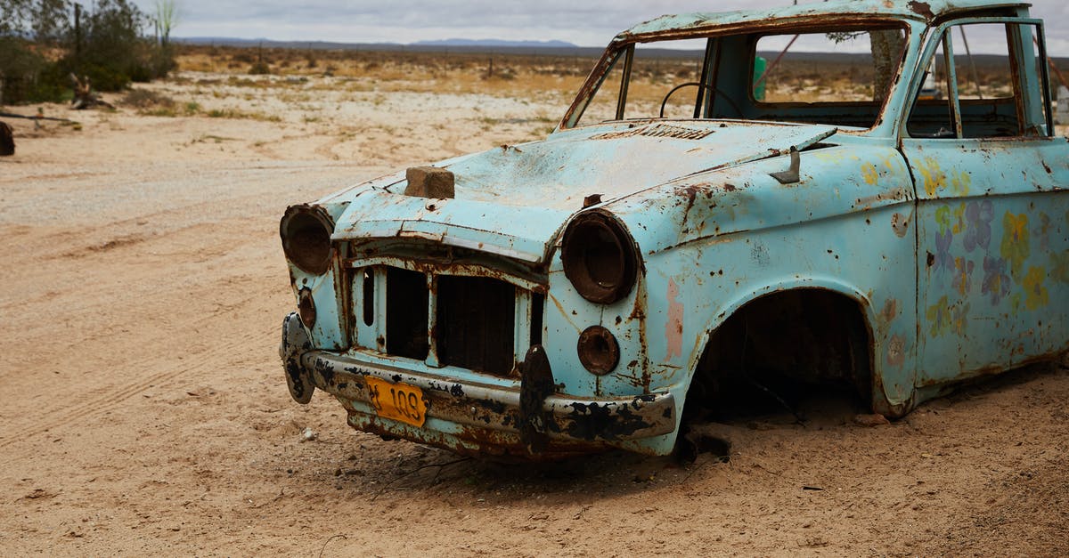 Are stone or metal grinding wheels better for flour? - Old rusty broken abandoned car without wheels and radiator placed in sandy terrain near tree