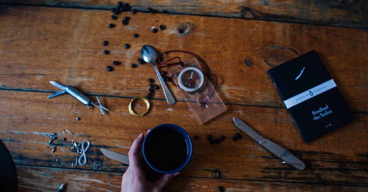 Are the Keurig K-Cups safe? [closed] - Person Holding White Ceramic Mug With Coffee on Brown Wooden Table