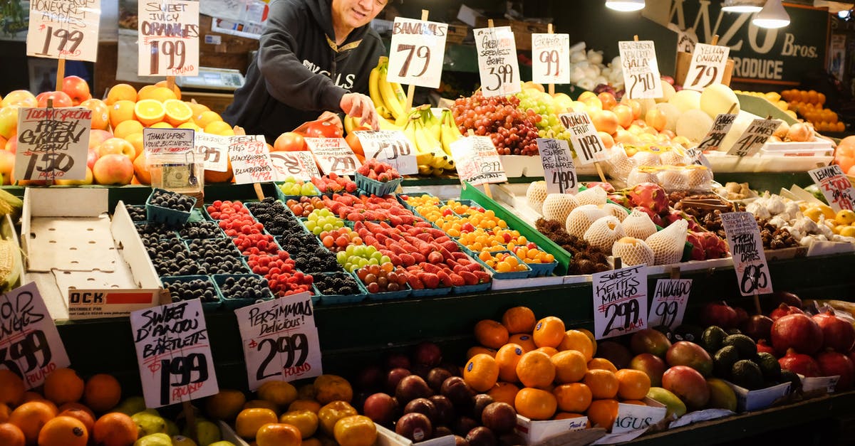 Are there any cons to heating orange and grape juice? - Ethnic vendor selling assorted fruits in local bazaar