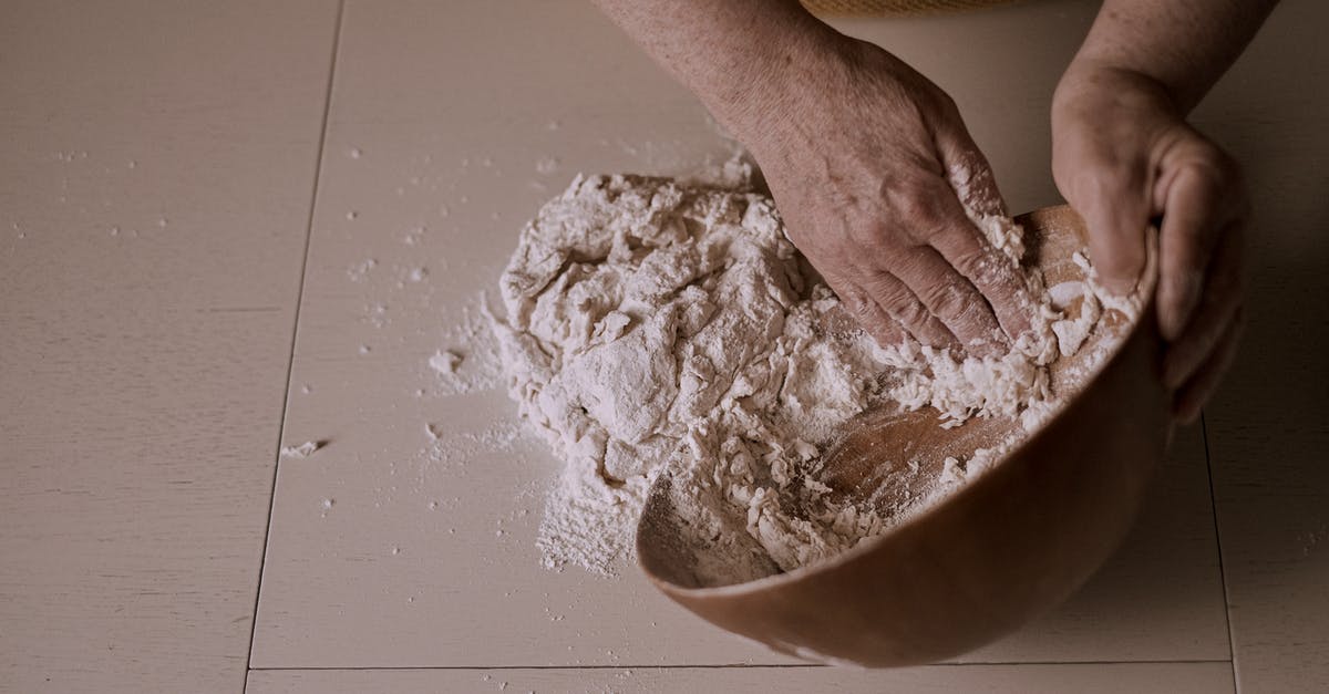Are there any negative effects to kneading bread dough longer? - Photo of a Person's Hands Kneading Dough