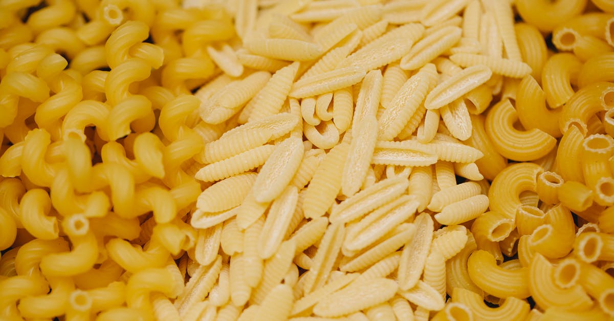Are there any particular type of corn chips that are made from masa flour? - Pile of assorted small pasta types scattered on table