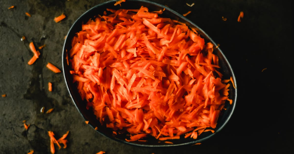 Are there culinary applications for carrot tops/greens? - Heap of orange fresh grated carrot in baking pan