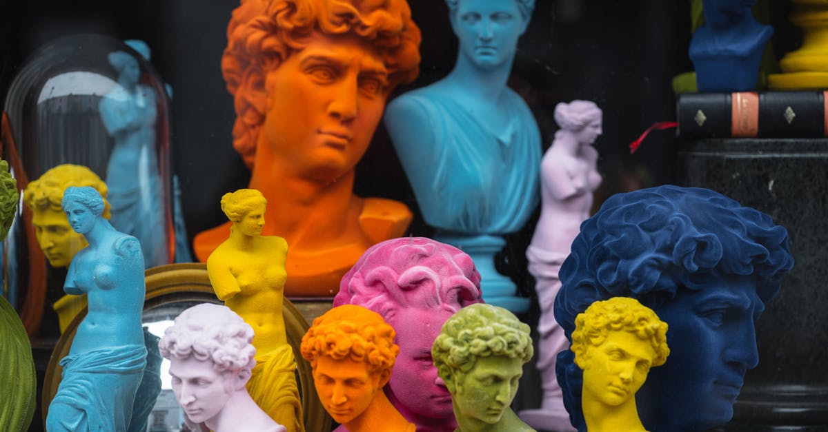 Are there different grades or styles of bacon? - Multicolored head sculptures of David near bright statuettes placed in store with abundance of souvenirs and black pillar with book