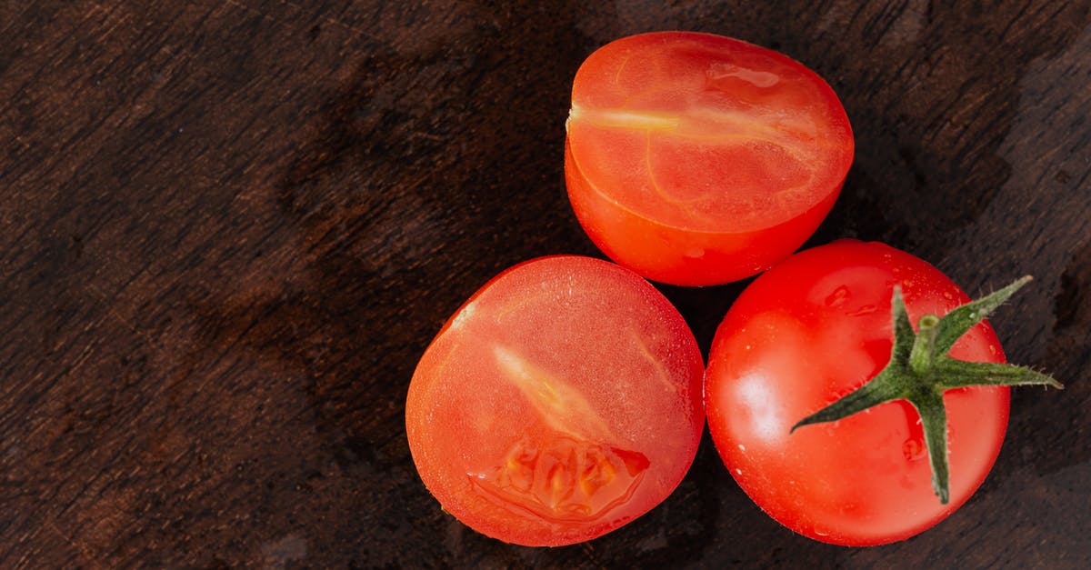 Are there other parts of a Lobster that are edible apart from the Tail and Claws? - From above of delicious juicy cut in half of tomato placed with red whole tomato on dark brown table