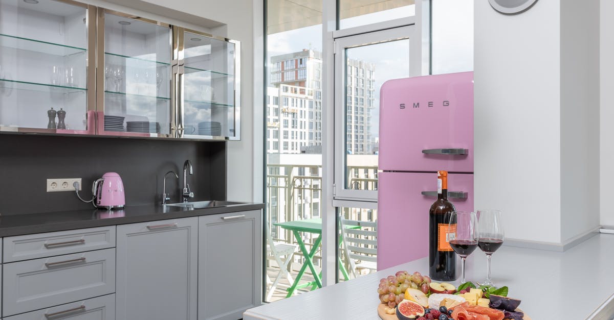 Are there "home" category powered refrigerated plates? - Plate with fresh delicious fruits placed near bottle of red wine on light table in stylish kitchen in daylight