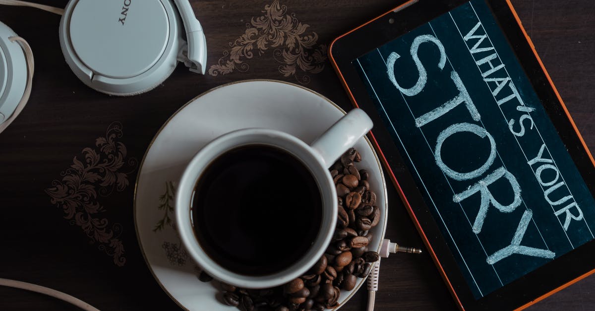 Are these coffee beans unroasted? - Top View Photo of Coffee Near Tablet