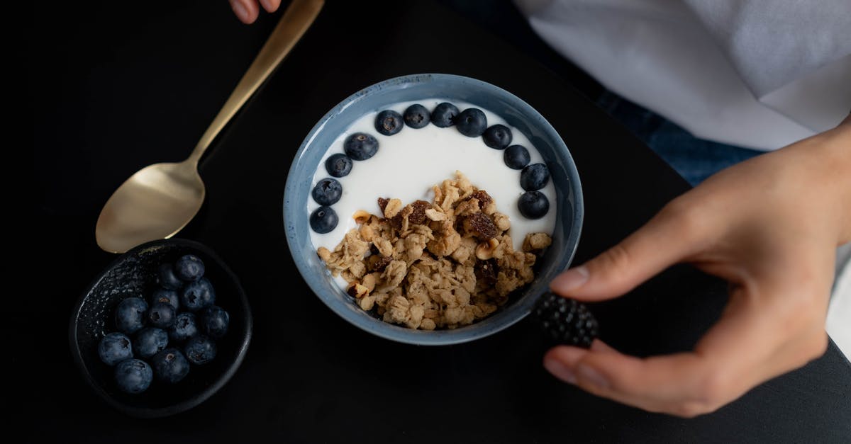 Are these Indonesian milk products cheese, yogurt, or curd? - Bowl with Granola, Milk and Blueberries on Black Table