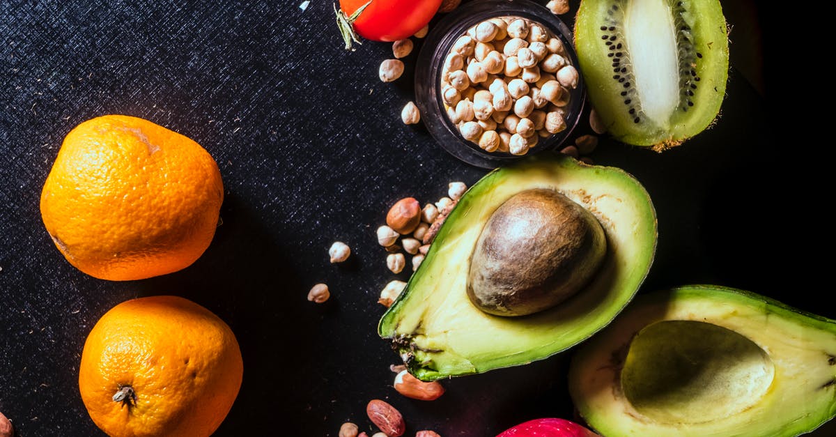 Are these vestigial seeds in a "seedless" orange? - Assorted Fruits on Black Textile