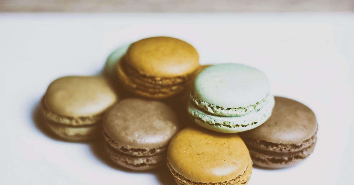 Art of making delicate French butter cookies (Madeleines) - Delicious set of various macarons placed on white table close to each other