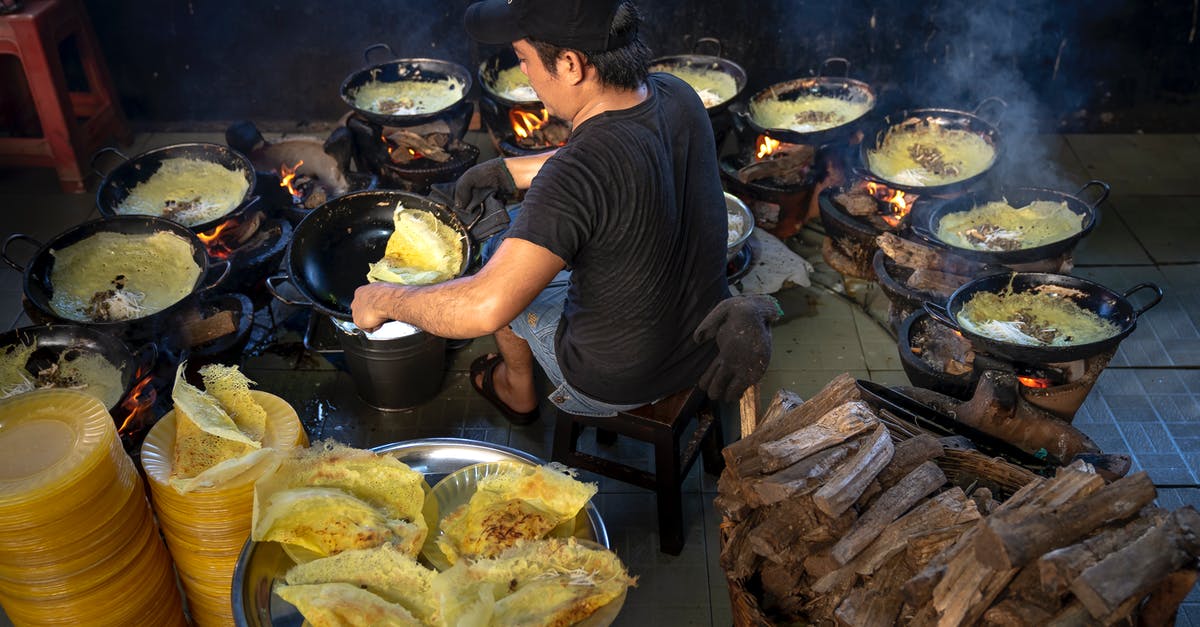 Attempted deep frying smoke fiasco - Photography of Man Cooking Surrounded by Woks