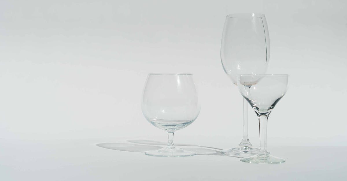 Availability of pure alcohol in the UK (or alternatives as fuel for alcohol-burning cookers) - Various transparent empty crystal glasses prepared for alcohol beverages against white background in studio