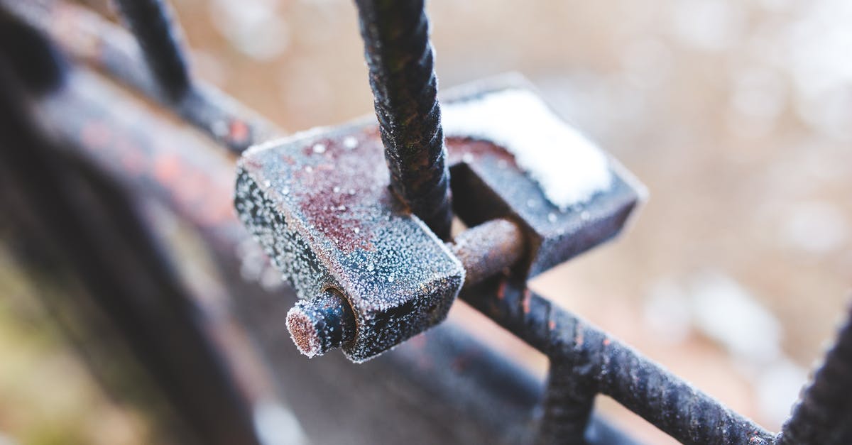 Avoid ice crystals in frappuccino - Rusty padlock covered with hoarfrost ice crystals