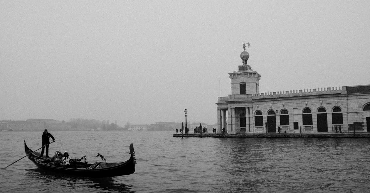 Béchamel and pomodoro - Grayscale Photo of Man Riding on Boat on Sea