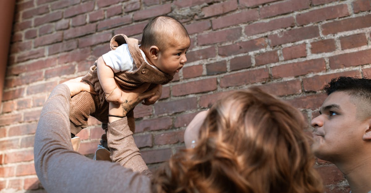 Baby parsnips vs. parsley root - Woman in Brown Long Sleeve Shirt Carrying Baby in White Shirt