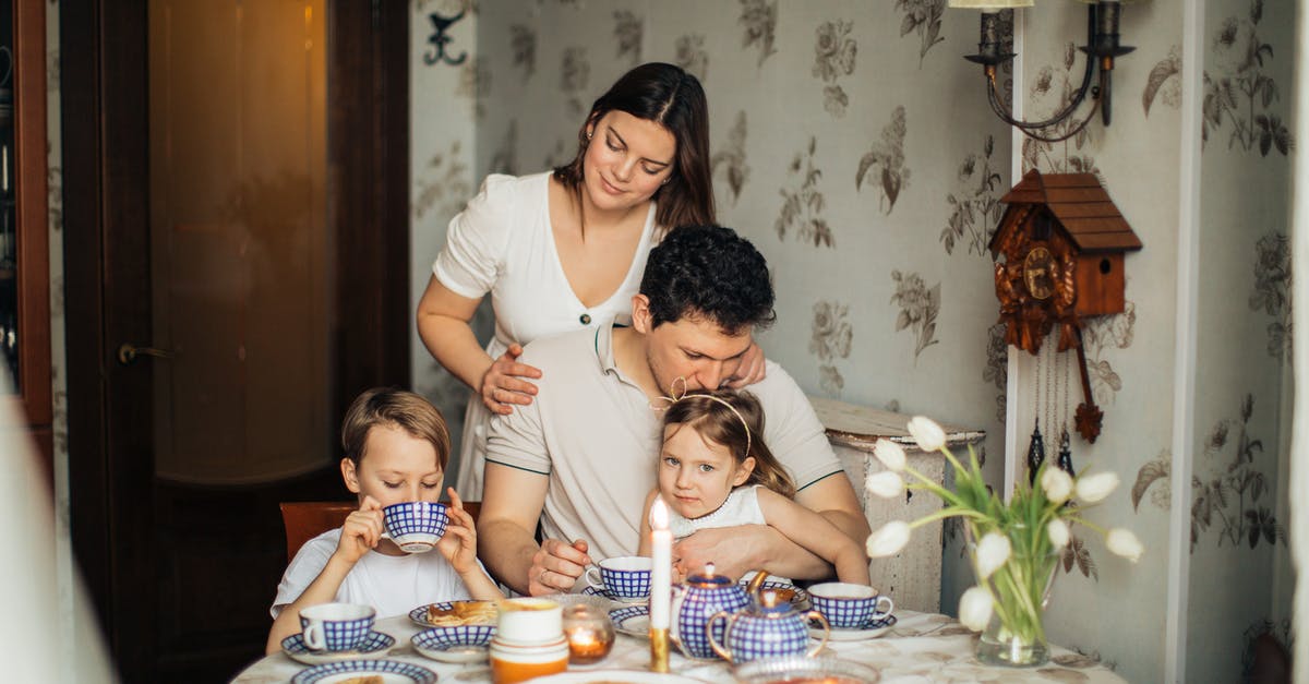 Bailey's curdled in coffee? - Cheerful family drinking tea at home