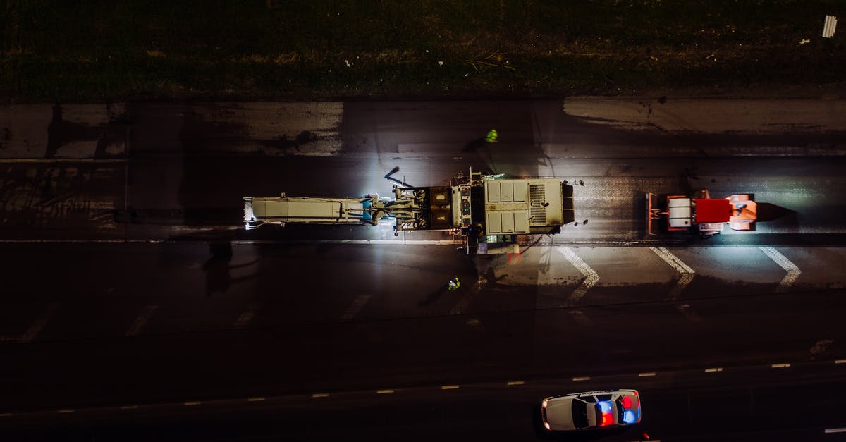 Baked eggplant is bitter - is there a way to fix it? - Top view of specialized vehicles with lights on repairing road and laying asphalt and concrete at night