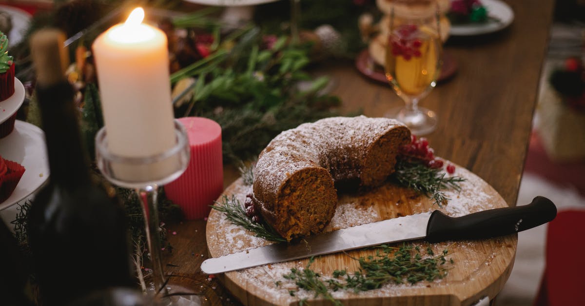 Baked item that would catch on fire/smoke? - From above of flaming candle near cake and glass of champagne with red berries during festive event at home