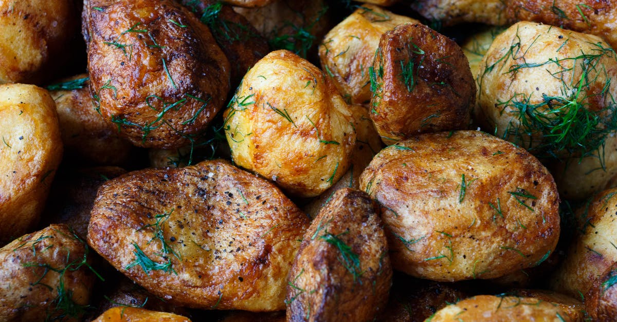 Baked Potatoes Cooked Over a Fire - Baked Potatoes With Rosemary Garnish