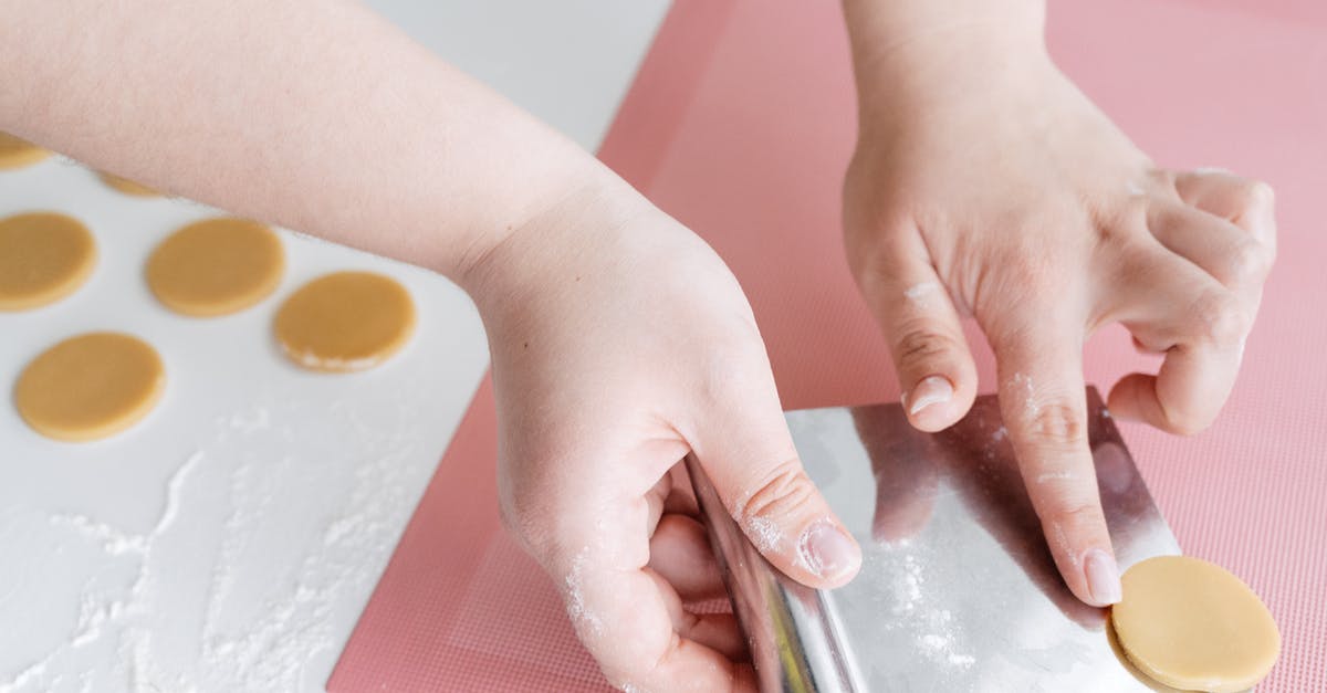 baking a Souffle to make it as much liquidish as possible - Crop woman placing unbaked cookies on baking mat