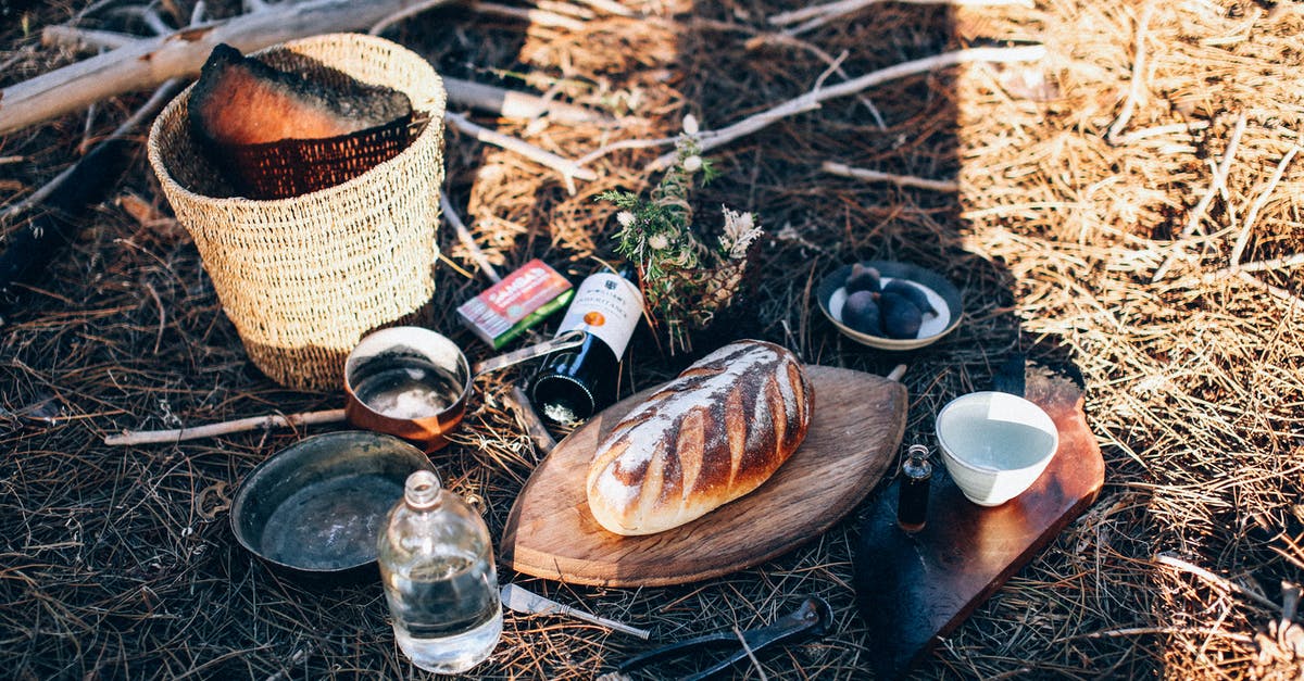 Baking in Glass Loaf Pan - Bread and utensil near bottles and basket on grass