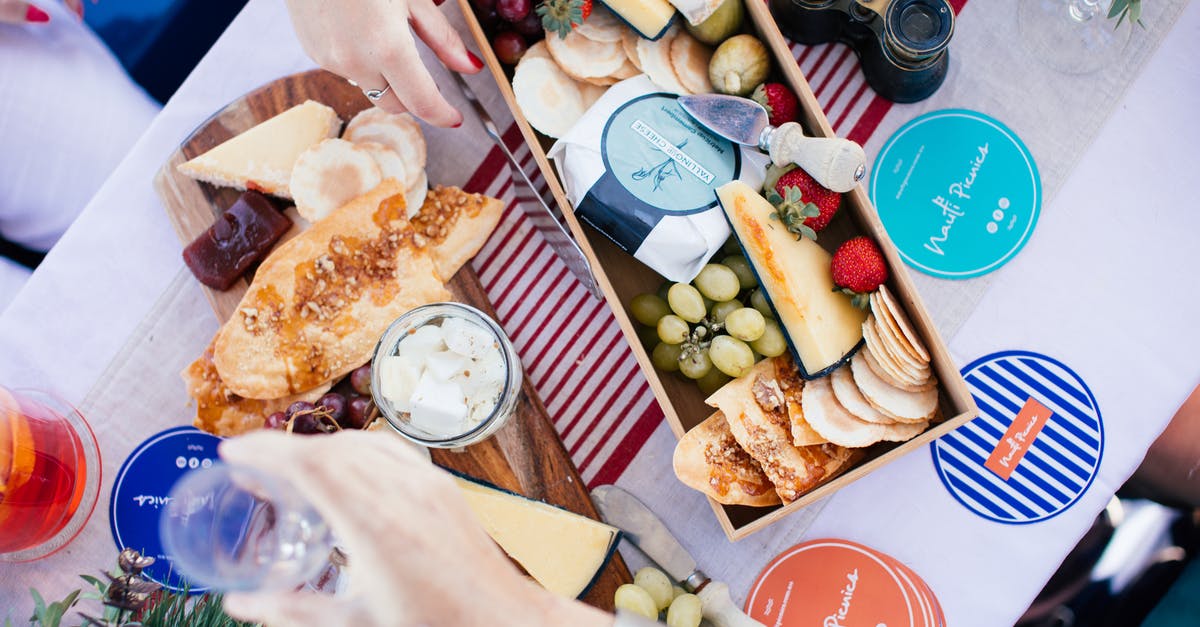 Baking with Whey Protein - Crop girlfriends at table with assorted delicacies and fresh fruits