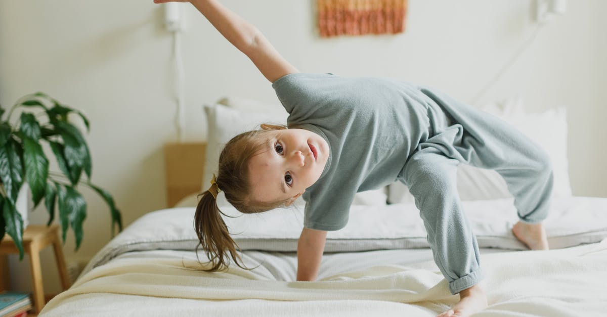 Balance overly sweet liqueurs - Adorable little girl having fun on bed at home