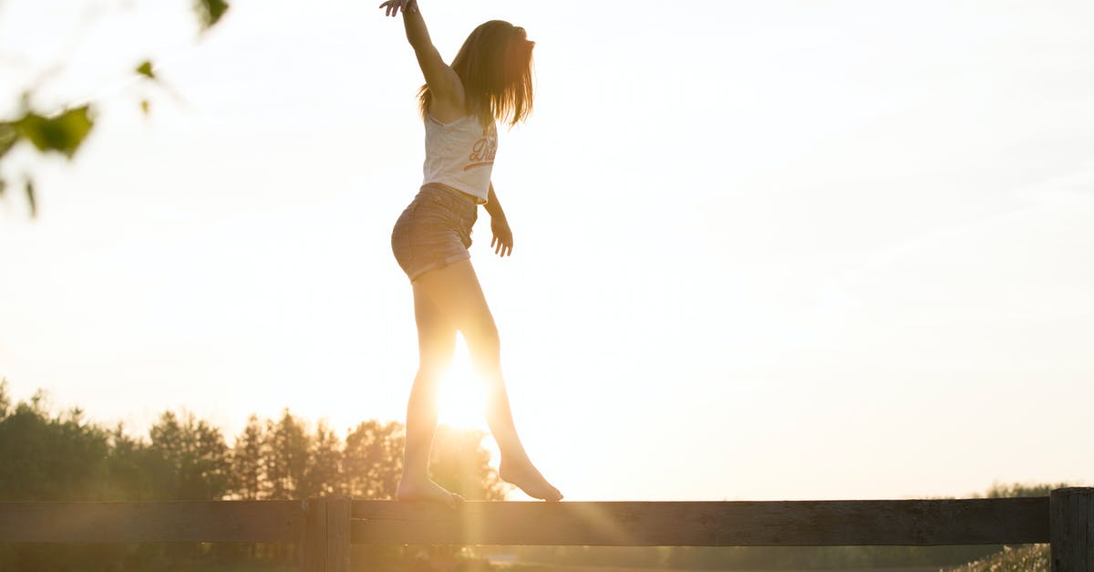 Balancing Flavours - Woman Walking On Fence