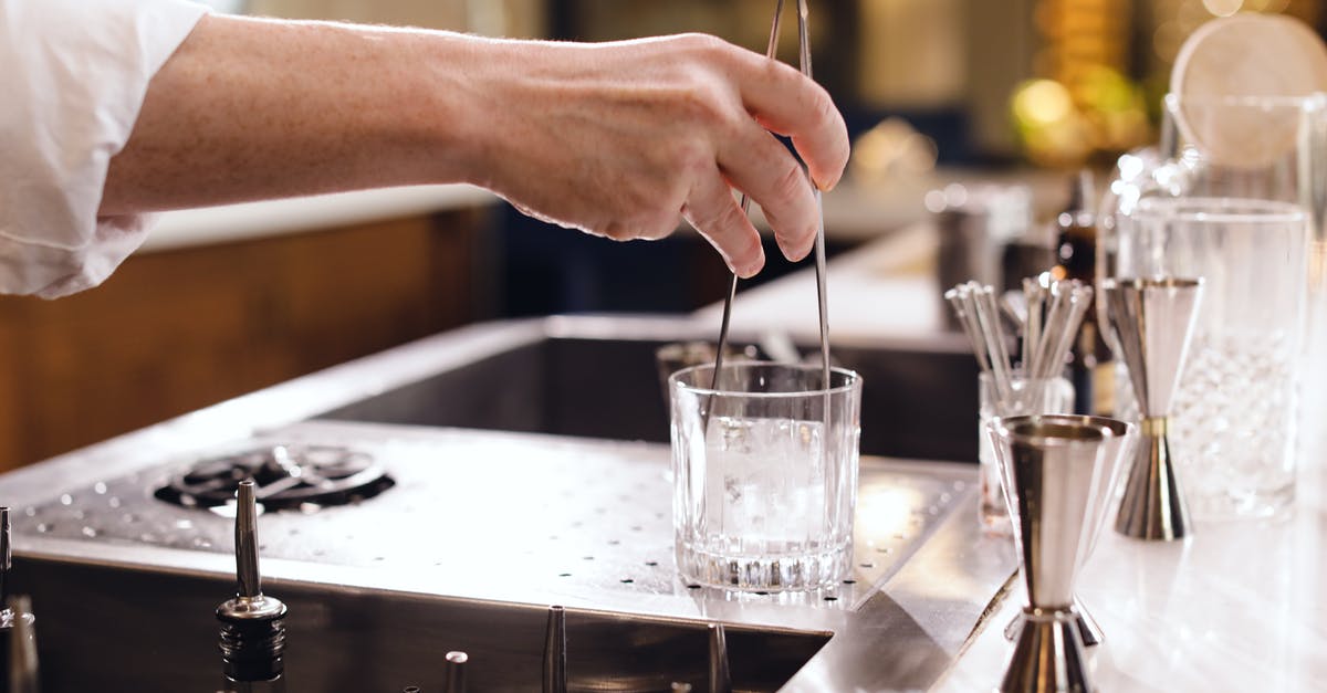 Bar ware - What kind of glass is this? - Person Pouring Water on Drinking Glass