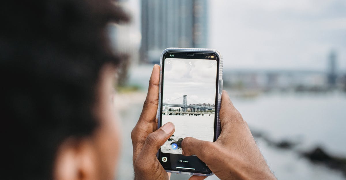 Bay used to crisp fermenting pickles - Black man taking photo of bridge over river