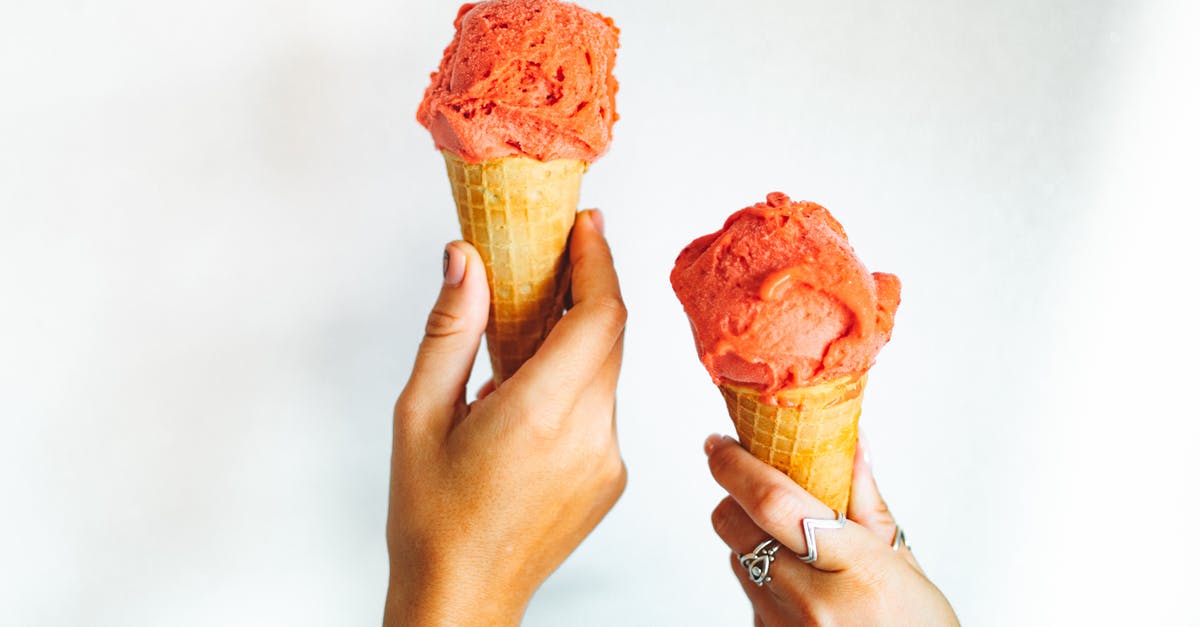 Beating eggs & sugar when making gelato - People Holding Strawberry Ice Cream in Cone