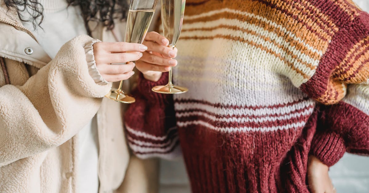 Best substitute wine glass - Crop faceless female friends in knitted sweaters clinking wineglasses of champagne during celebration together