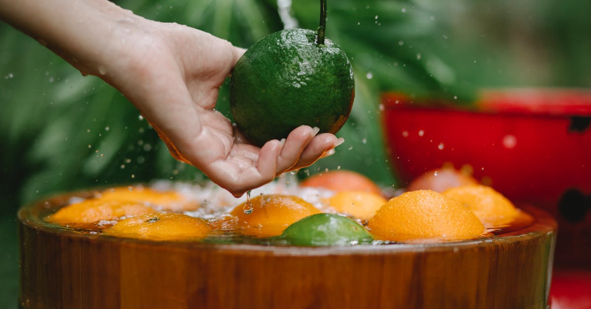 Best vegan substitute for egg wash - Crop woman washing fresh fruits in bowl