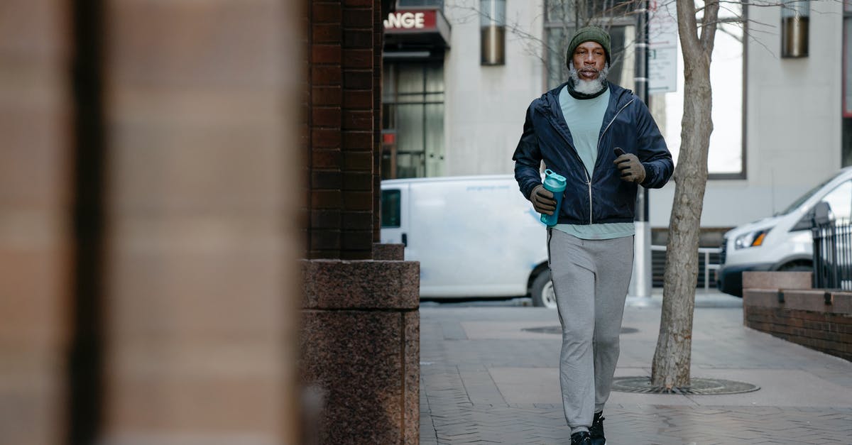 Best way to bottle peri peri sauce? - Serious African American male jogging on pavement in city