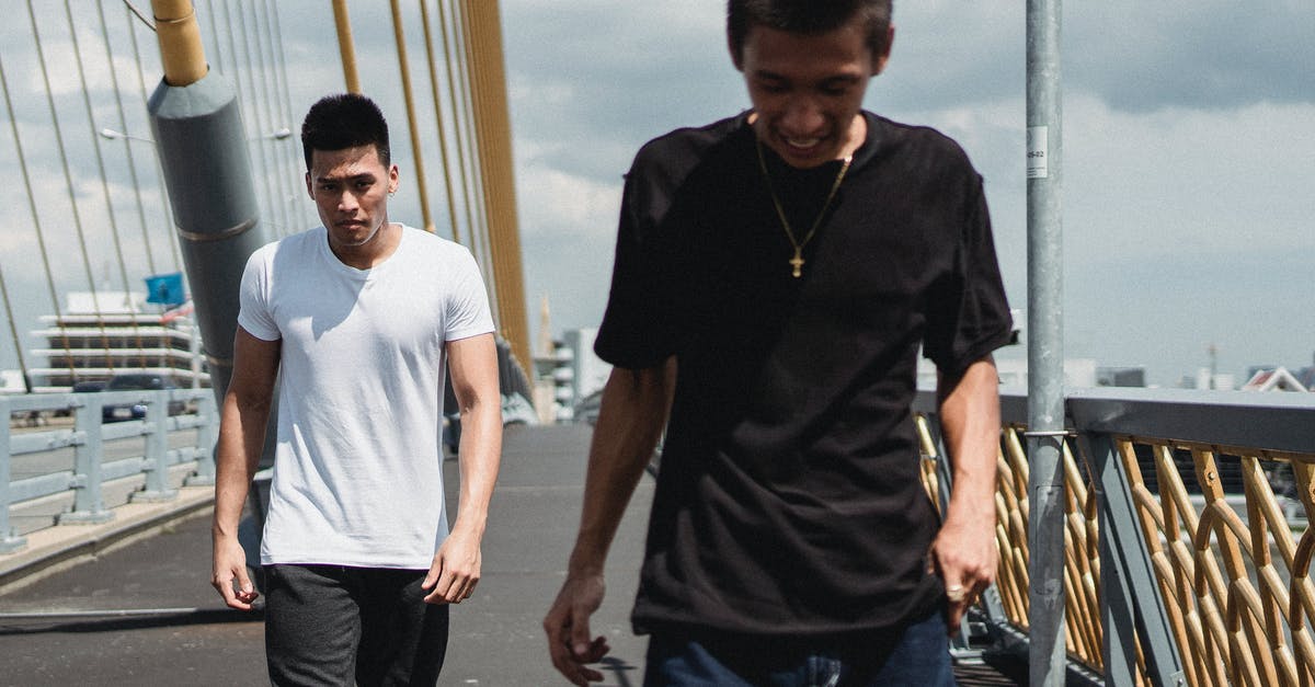 best way to preserve ricotta? - Young Asian men walking on asphalt bridge