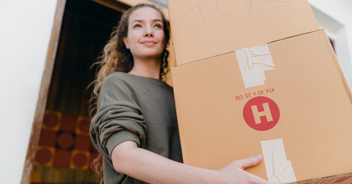 Best Way To Remove Fajita Contents From Marinade - Confident young lady in casual wear carrying heavy carton boxes with toys and looking away while leaving old house