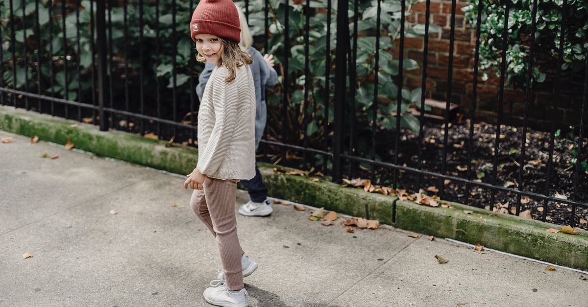 Best Way To Remove Fajita Contents From Marinade - From above full body of cheerful girl and boy strolling on walkway along metal fence and green bushes on street