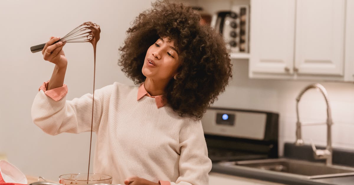 Biscotti with chocolate drizzle in batter - Cheerful black woman with batter flowing from whisk