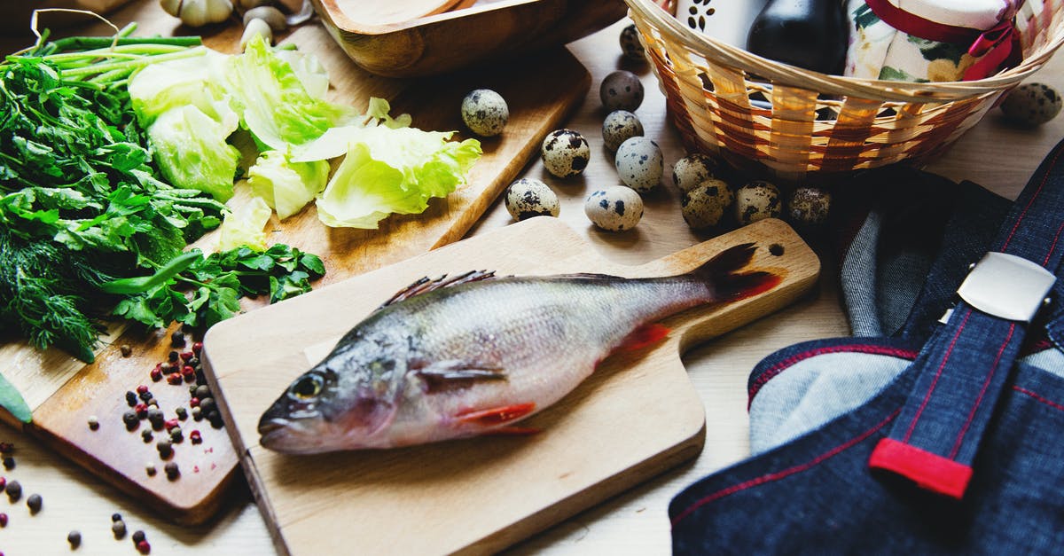 Black Garlic Maillard vs caramelization - Raw fish on cutting board with lettuce in kitchen