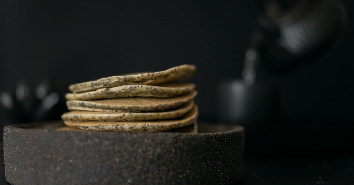 black residue in tea kettle - Tasty pancakes on table with teapot