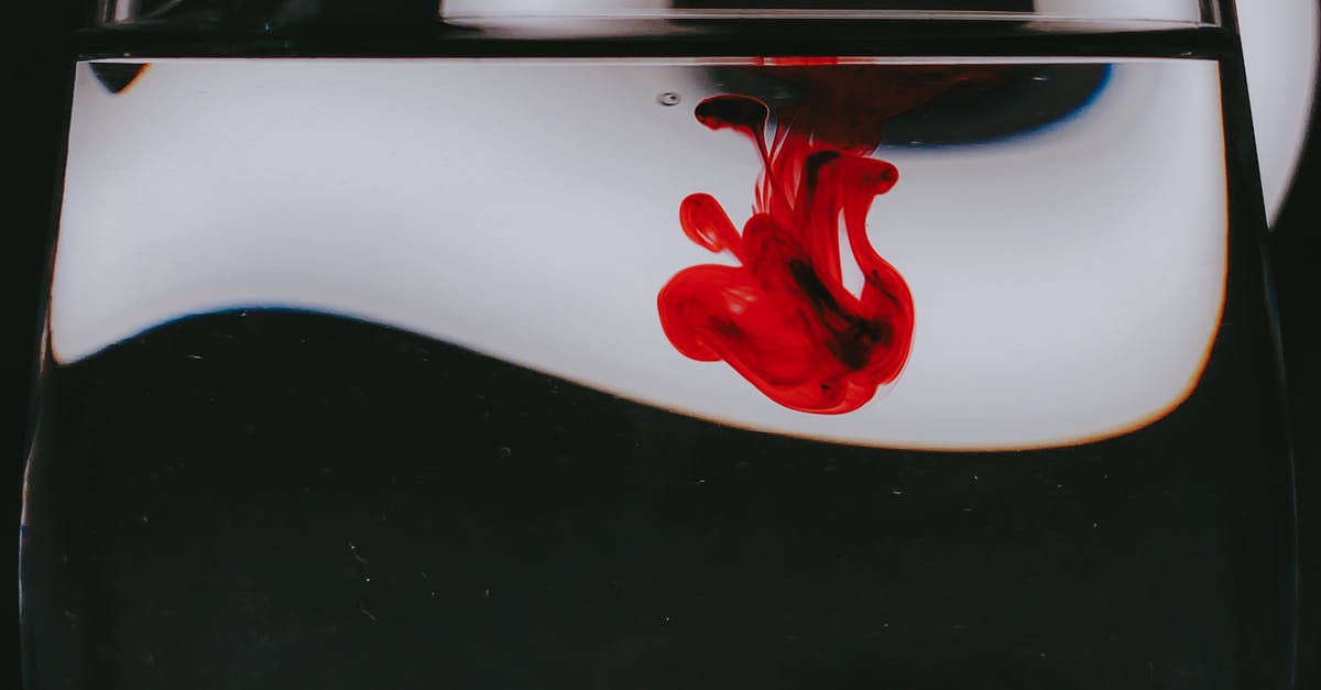 black stain on my glass stove top - Red dye spilled into glass of water