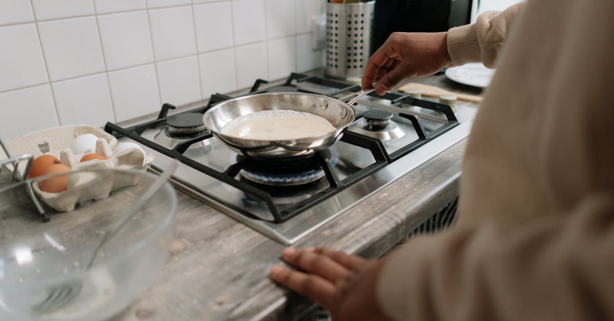 Blending eggs for omelette? - Person Holding Stainless Steel Cooking Pan