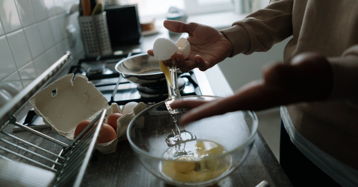 Blending eggs for omelette? - A Person Cracking Eggs