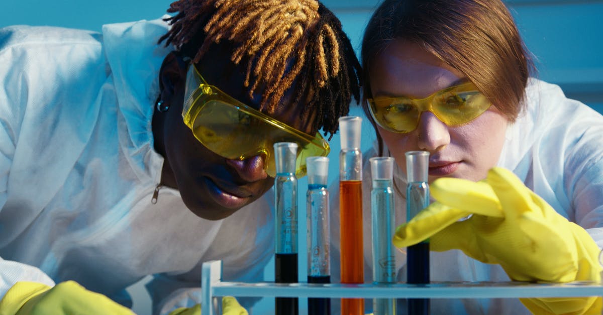Blending pineapples and coconuts whole, safety and experience? - A Man and a Woman Looking at the Test Tubes