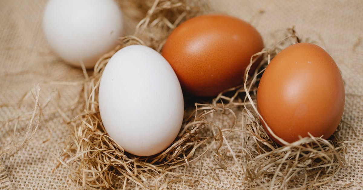 blood in poultry farm white egg - Chicken eggs among straw on table