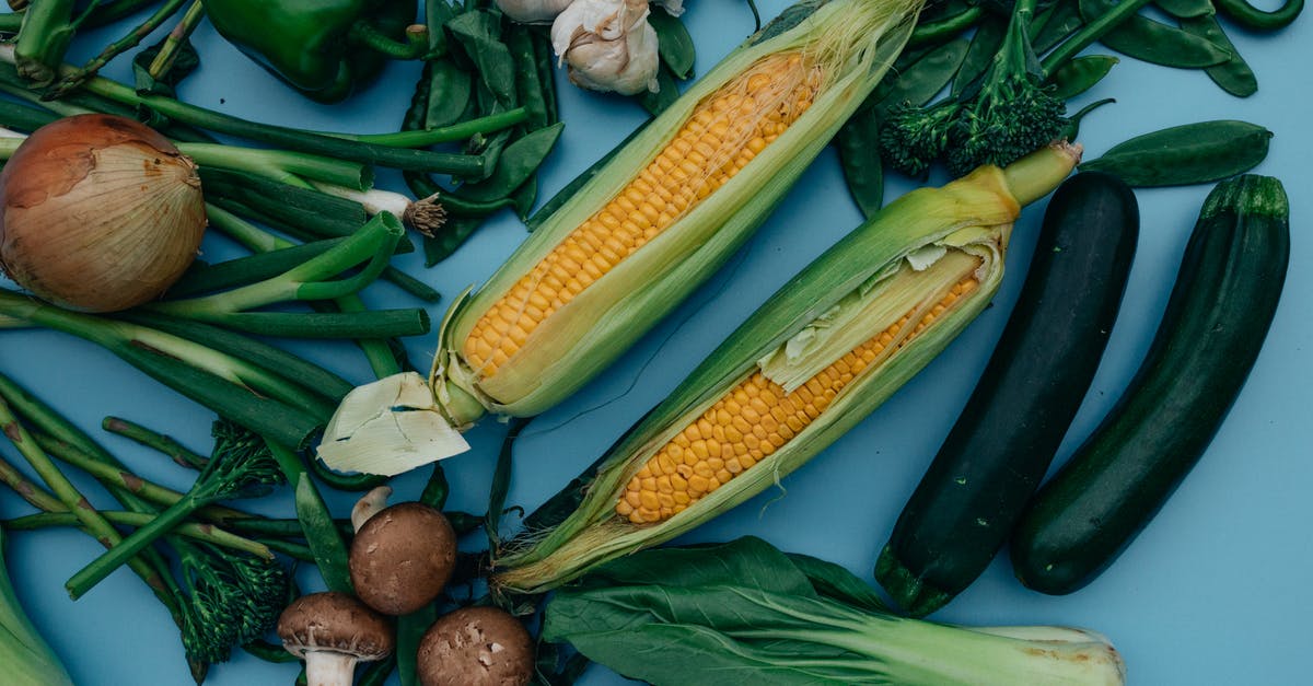 Blue garlic during pickling - Vegetables and Corns on Blue Surface