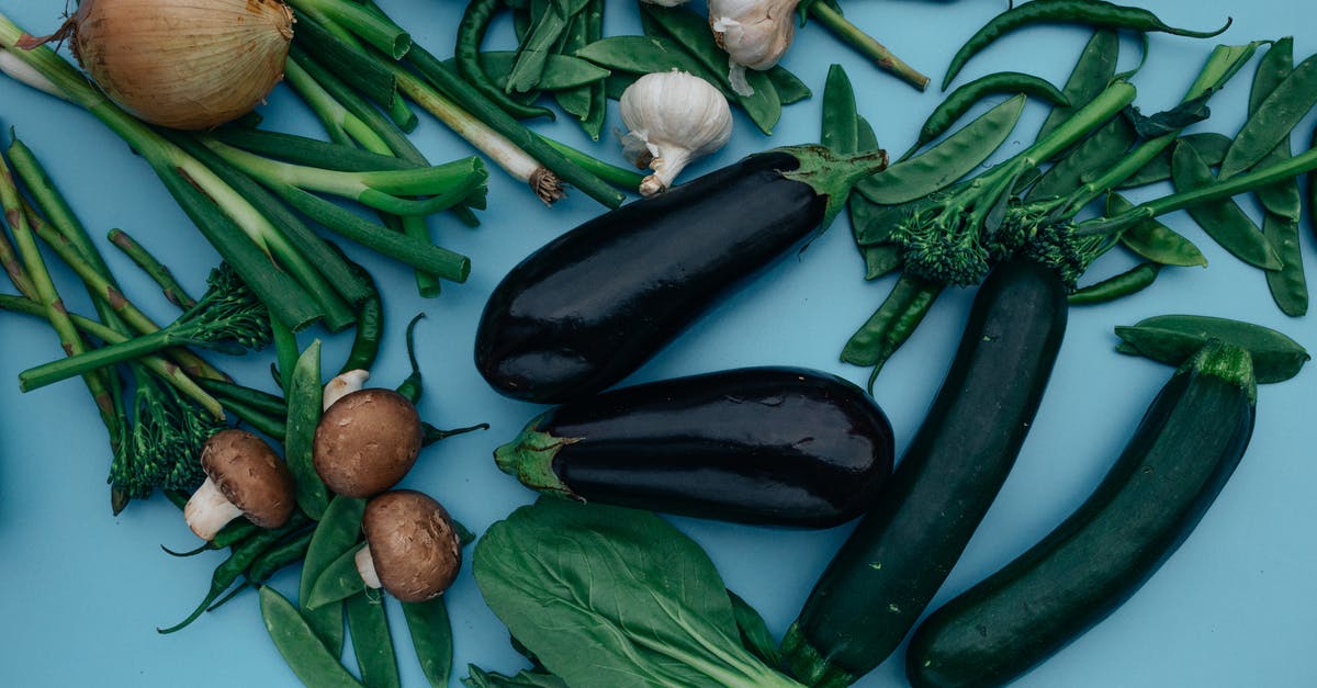 Blue garlic during pickling - A Mixed Vegetables on a Blue Surface