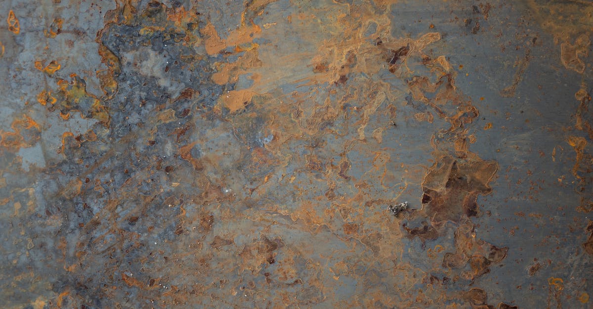 Blue spots in omelette? - Textured background of aged shabby blue wall with light brown paint and cracks on surface