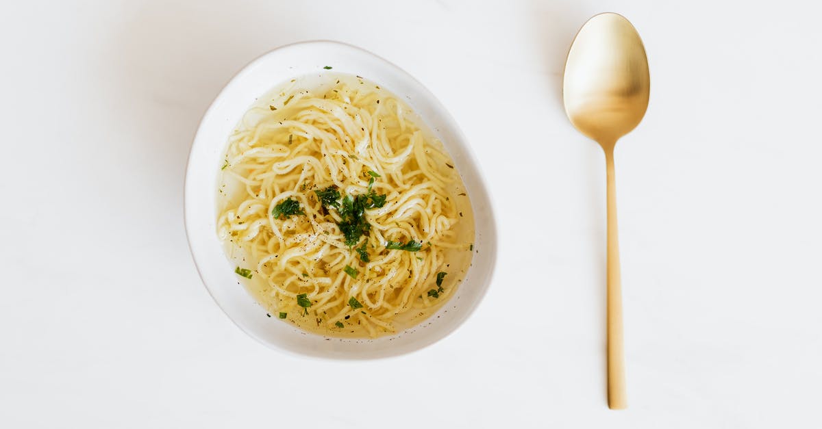 Bone broth has green tint; is this normal? - Bowl of noodles with golden spoon