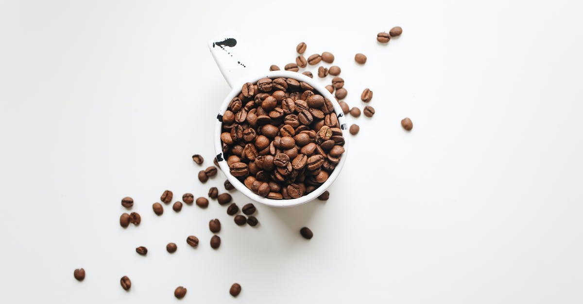 Both over- and undercooked beans from a pressure cooker - White Ceramic Mug Full Of Coffee Beans