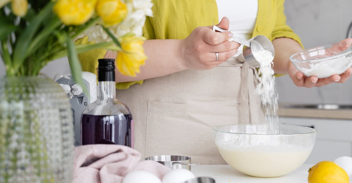 Bottle of Cachaça 51 tasting like sour milk? - Crop woman pouring flour in bowl in kitchen